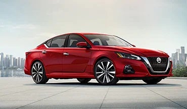 2023 Nissan Altima in red with city in background illustrating last year's 2022 model in Wallace Nissan of Kingsport in Kingsport TN