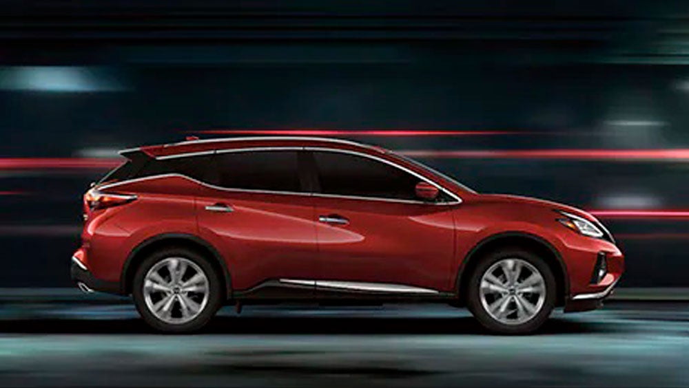 2023 Nissan Murano shown in profile driving down a street at night illustrating performance. | Wallace Nissan of Kingsport in Kingsport TN